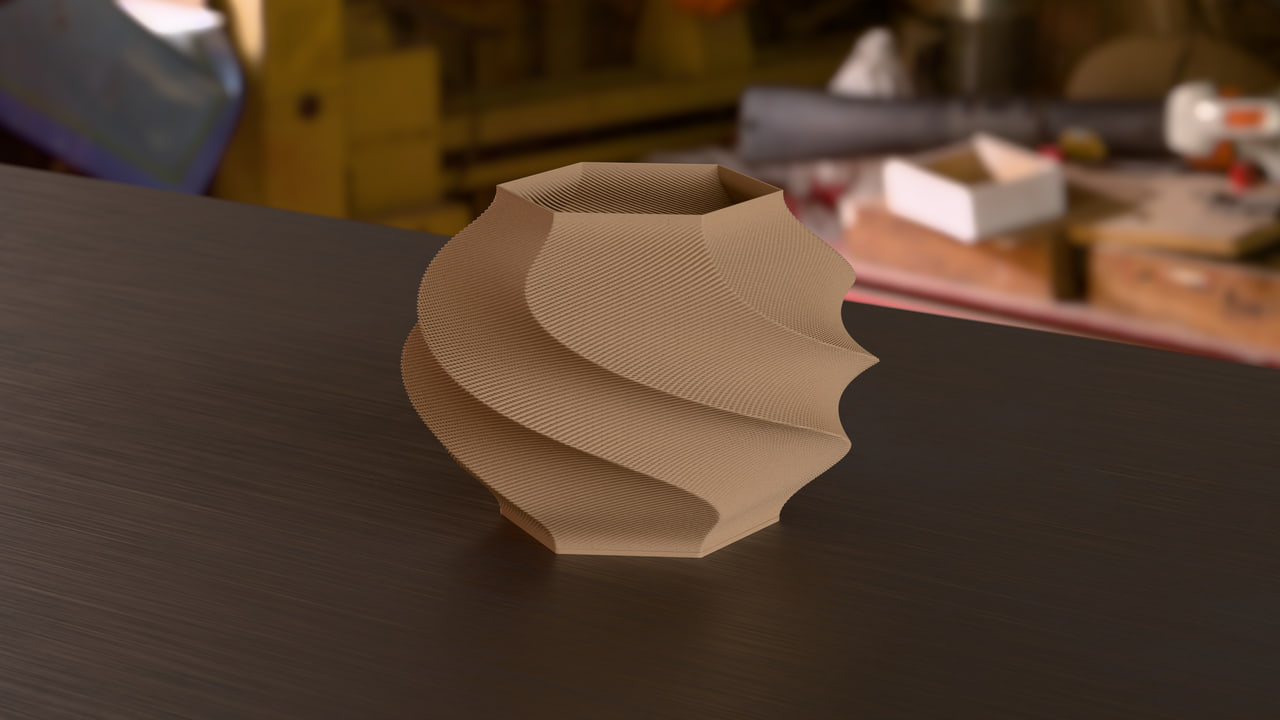 The Gelato lamp in PLA Matte Latte Brown in the maker's bench set, under shop light light.