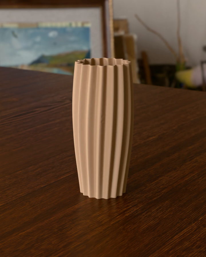 The tall fluted vase in Bambu Lab PLA Matte Latte Brown on the wood table, the first frame of its turn.